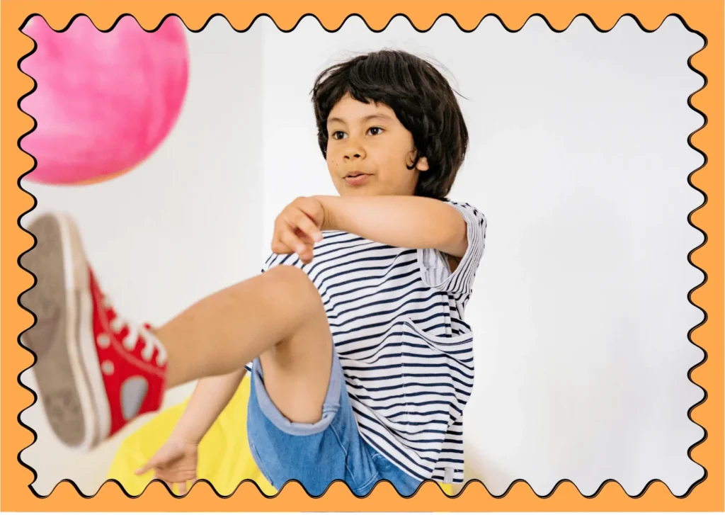 Young boy kicking a balloon. Balloon games for young kids